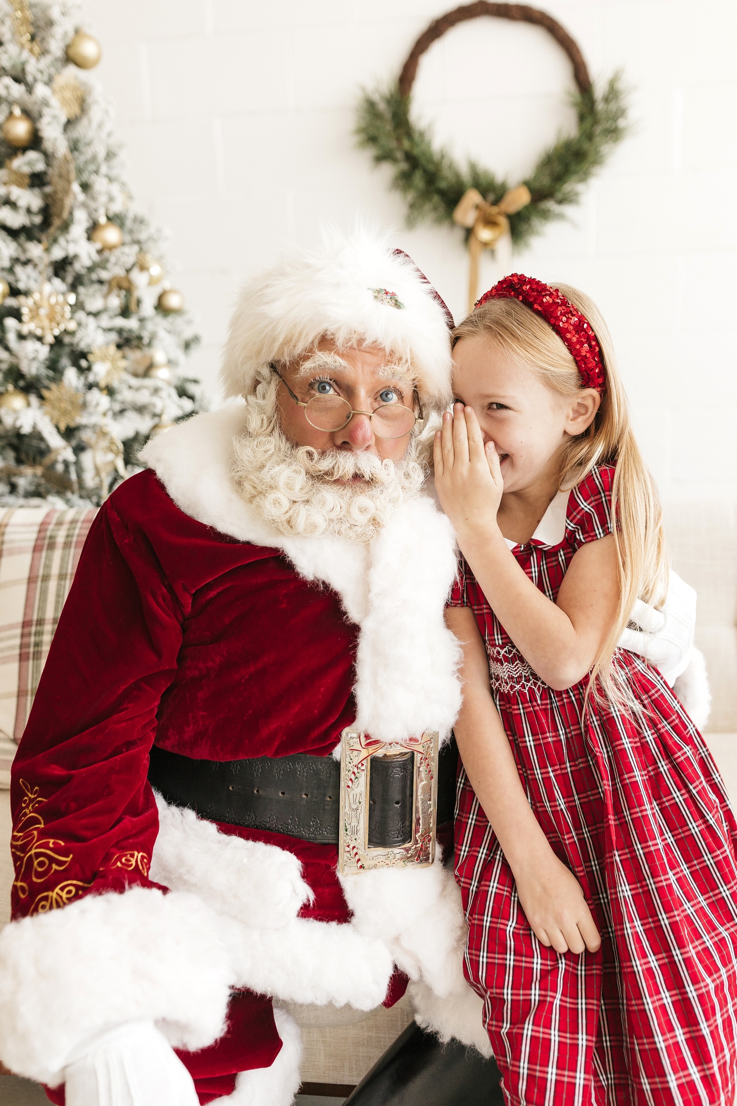 Santa Albert listening attentively as a child shares a Christmas wish