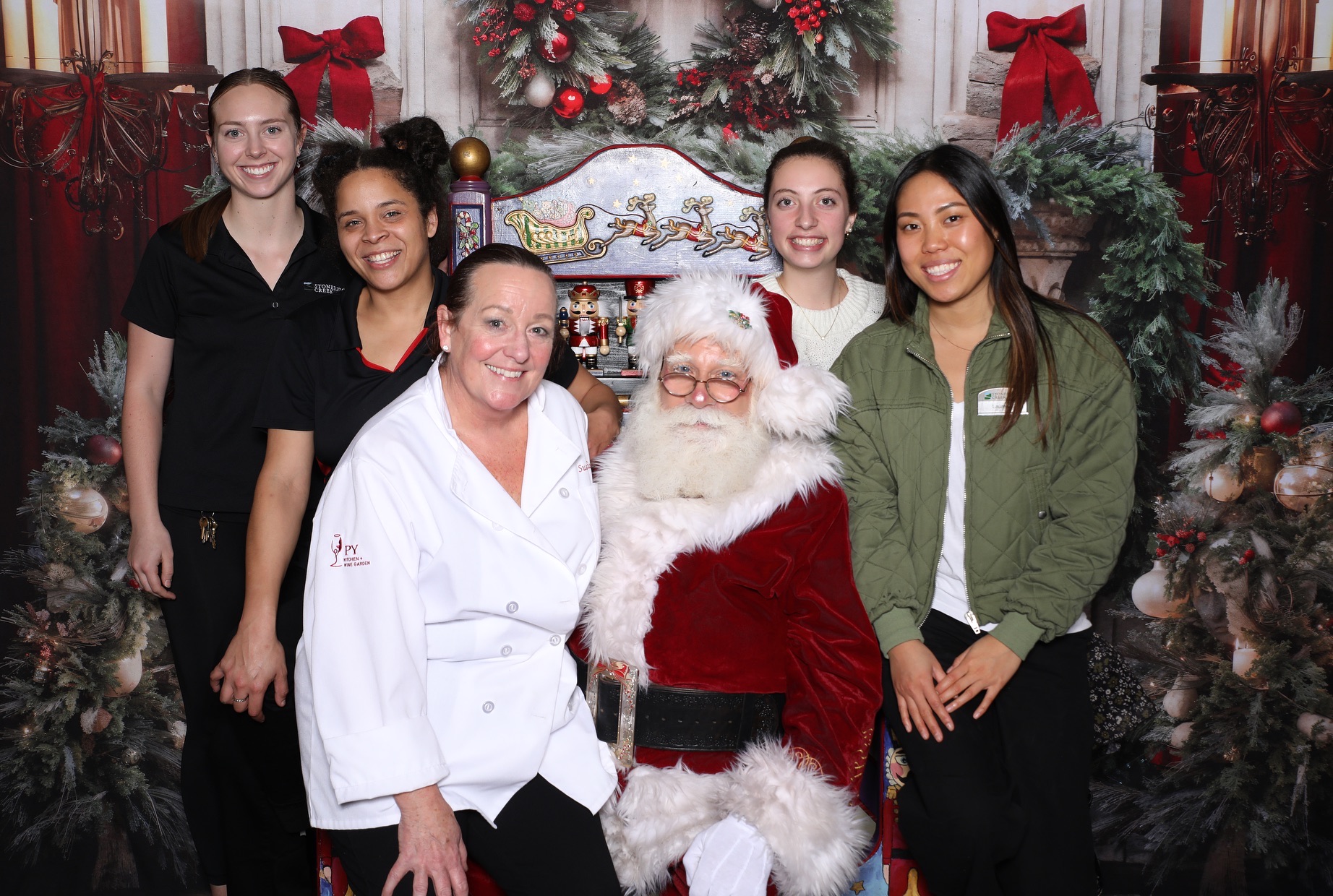 Santa Albert with staff members at Stoneridge Creek in Pleasanton, California, in 2024