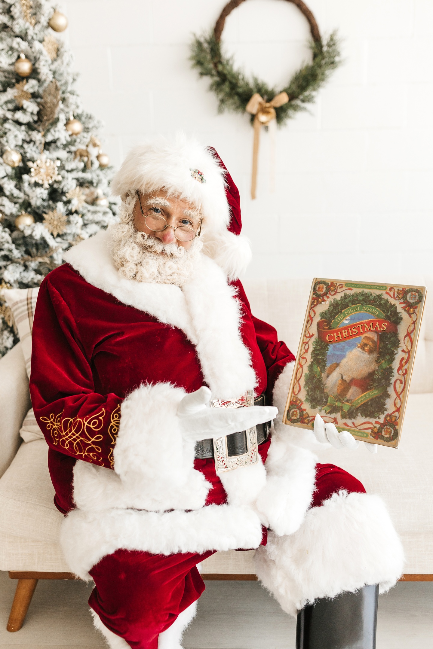 Santa Albert holding The Night Before Christmas in a festive holiday setting