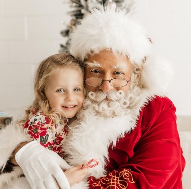 Santa Albert with a child during a professional Santa Claus appearance in the San Francisco Bay Area