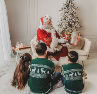 Santa Albert Reading a Christmas Story During a Family Home Visit