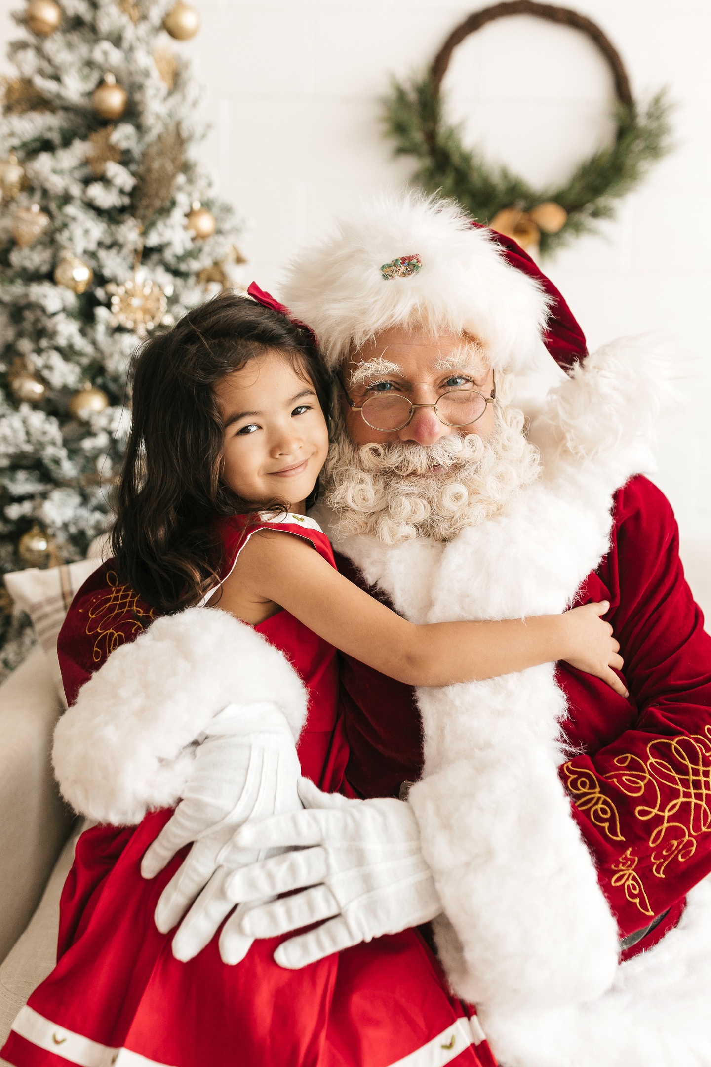 Child sharing a joyful holiday moment with Santa Albert